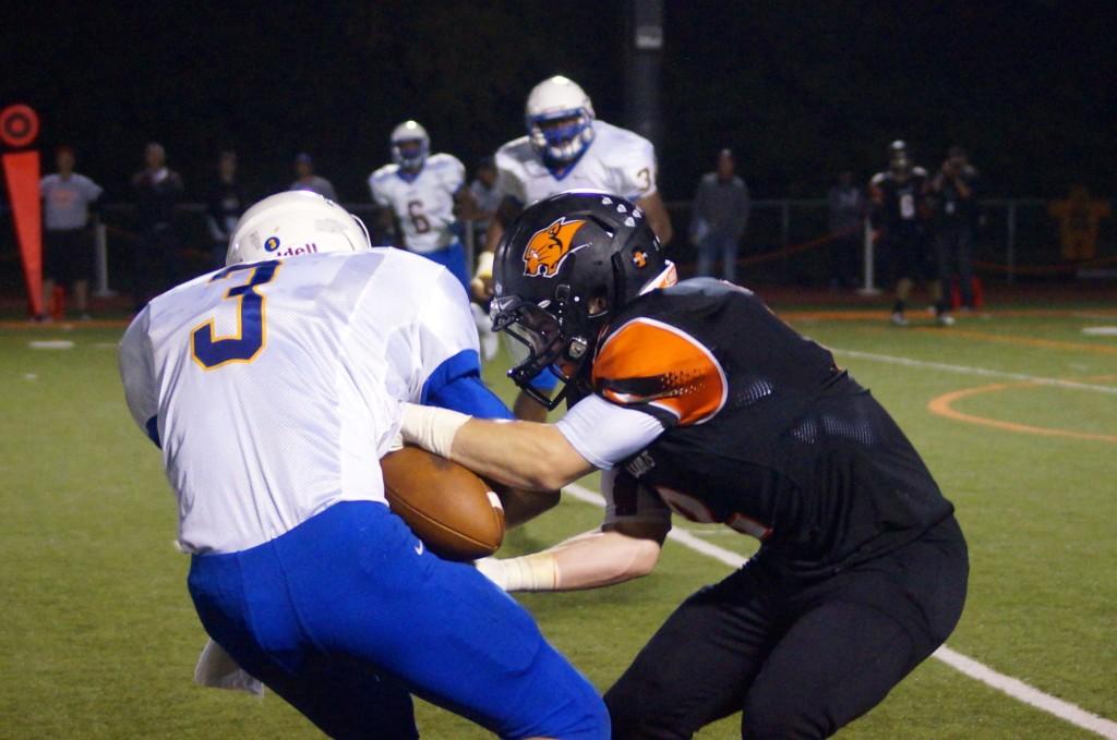 Senior Conor Simpson goes for the strip on the Warren ball carrier.
