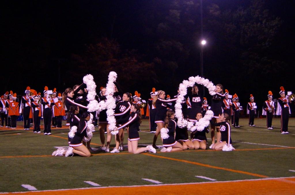 LHS Poms use their pom poms to spell out HC in honor of the Homecoming game.