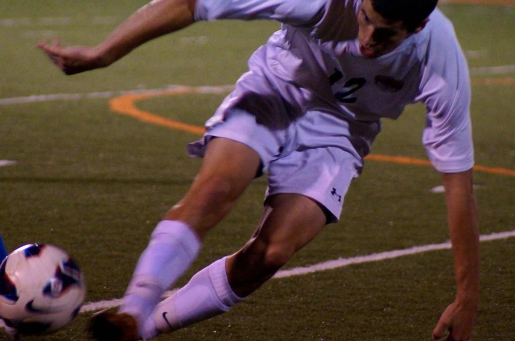 Senior Ryan Dawson slides to keep the ball from going out of bounds.