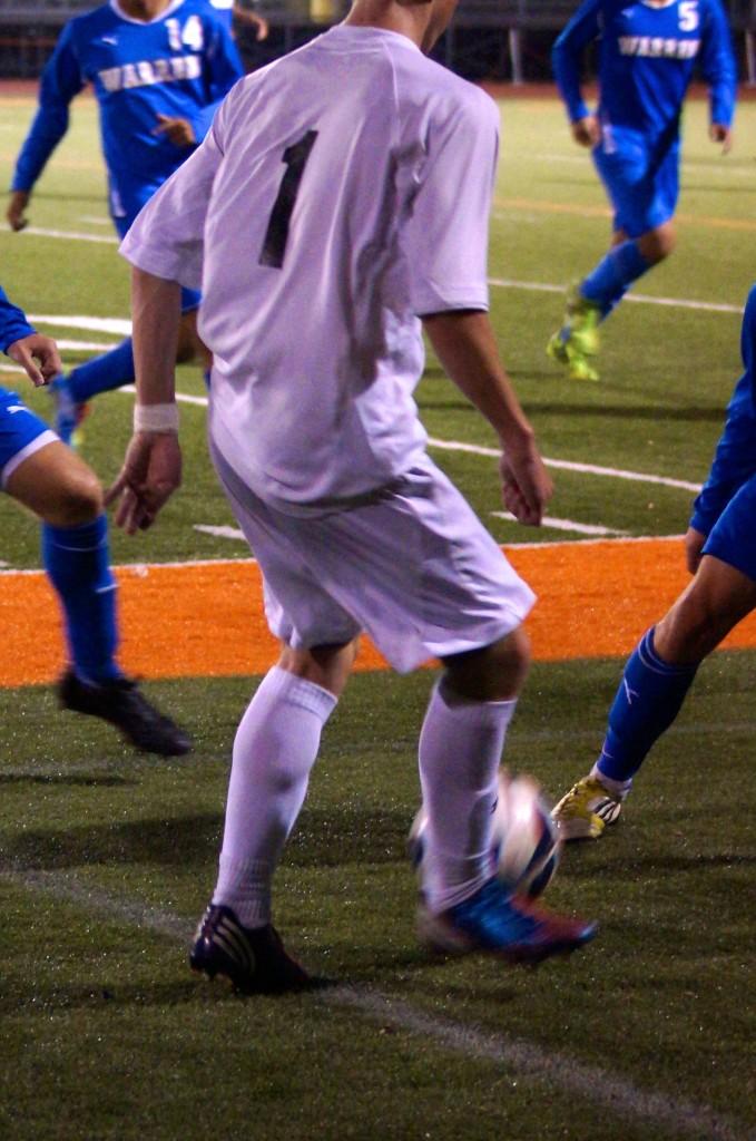 Sophomore Laim O Connell maintains control of the ball despite heavy Warren pressure.