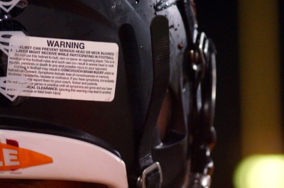 A warning sticker on the back of LHS football helmets notifies players of the dangers of head injuries that a helmet cant entirely prevent.