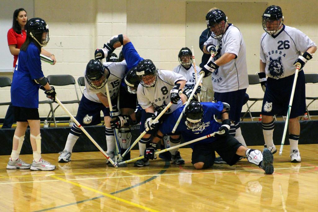 Storm players battle for the puck during their 11-4 state final victory over the NEDSRA White.