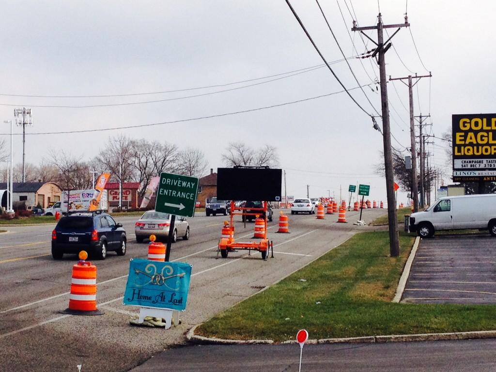 The entrance to Home at Last and the other retailers by Peterson Commons is littered with construction cones and signs.   