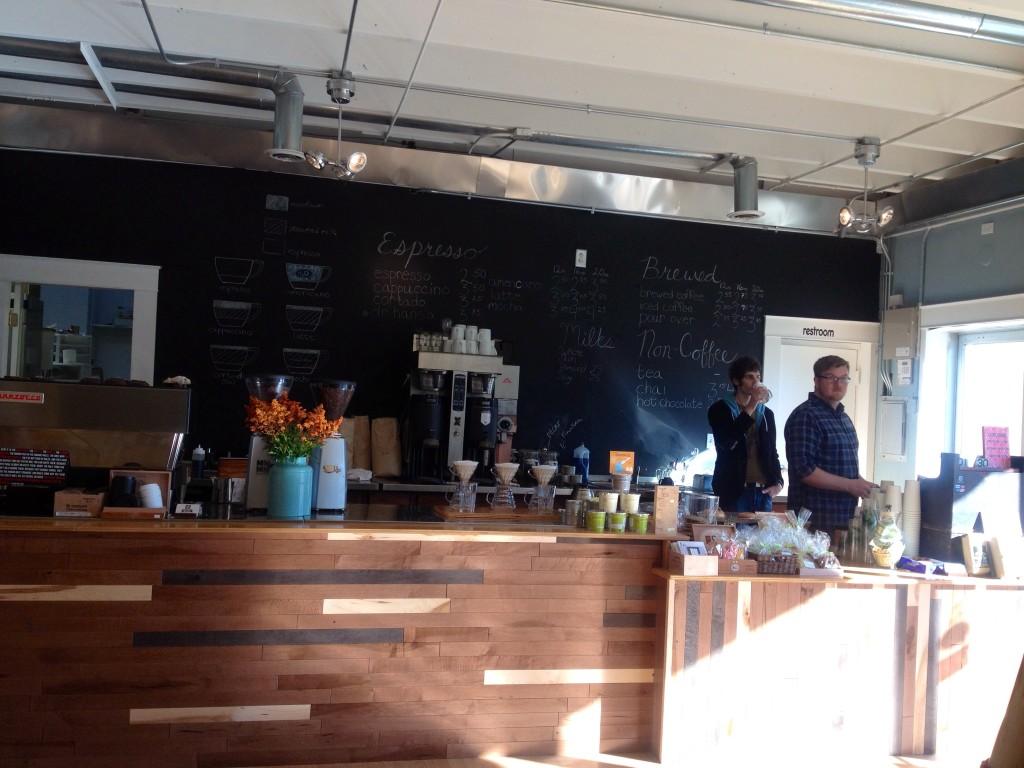 The inside of Hansa Coffee Roasters features high-tech brewing machines and a wide variety of food items.