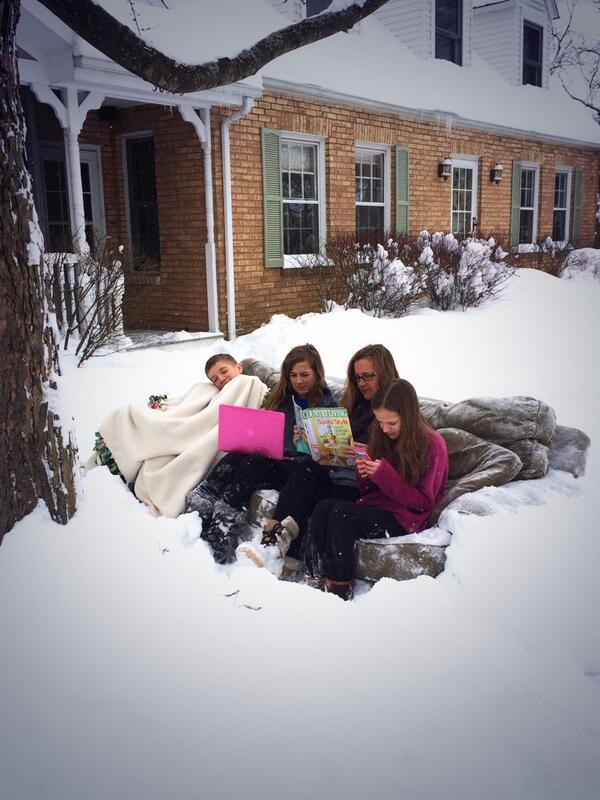 The Dean family sitting on the couch in the snow on Thursday.