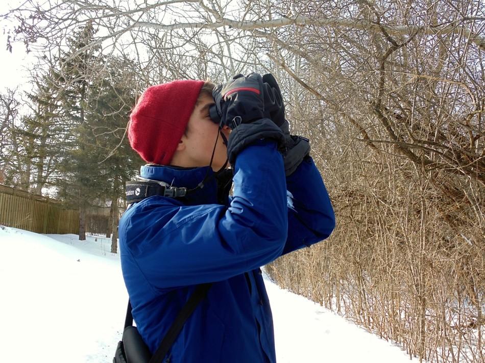 Junior Nick Minor searches for birds among trees. 