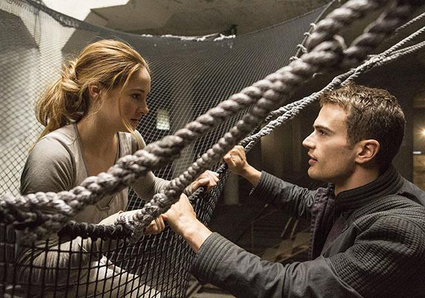 After Tris (Shailene Woodley), jumps off of the building, Four (Theo James), helps her out of the net