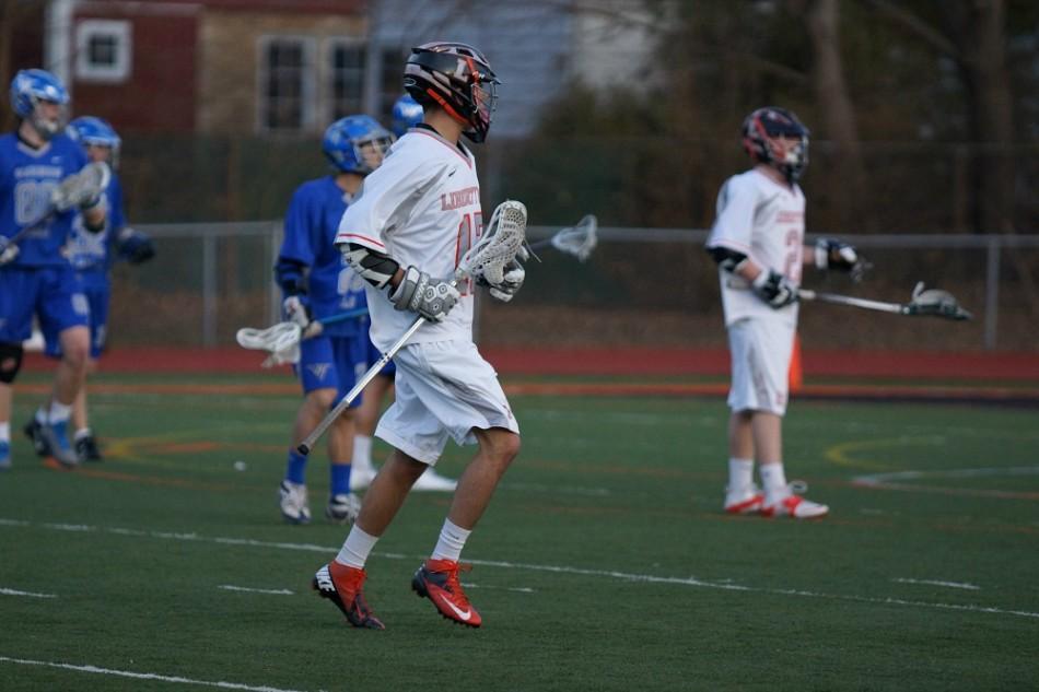 Junior Brett Becker cradles the ball in a game against Vernon Hills on April 9. 