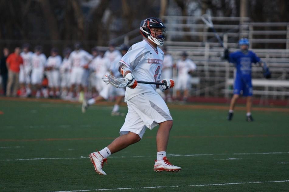 Junior Henry Burns cradles the ball while playing against Vernon Hills on April 9. 