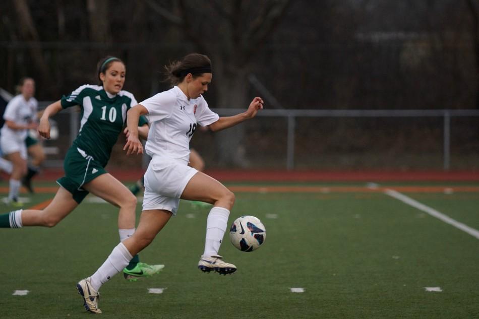 Senior Ali Urbanski dribbles the ball towards goal to shoot. 