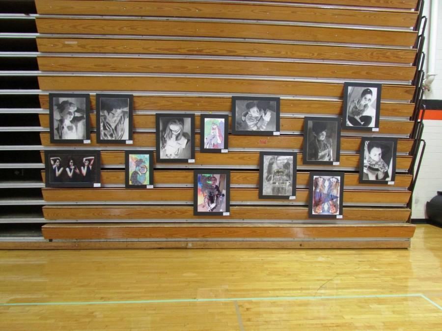 Many self portraits, including Emily Schuler's, were hung on the bleachers.