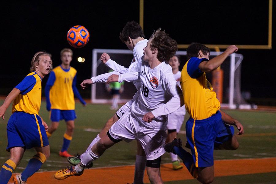 Junior Jacob Rasmussen and Sophomore Michael Quigley go for the header. 