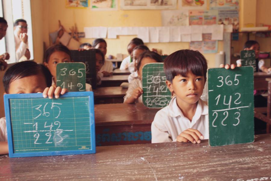 Cambodian school children participating in math class.