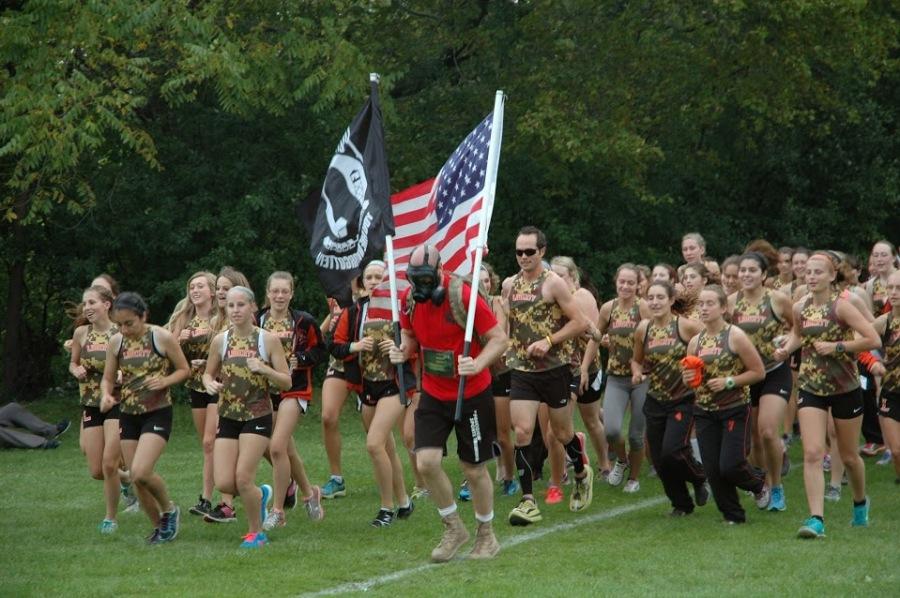 The girls cross country team follows Mark Robinson to the finish line at the LHS Invite. 