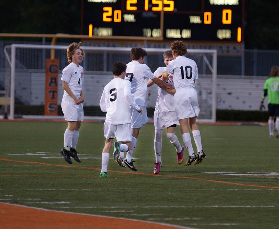 Senior Sam Kratzer celebrates a free kick goal with teammates.