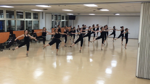 Varsity Poms prepares in the lunchroom for upcoming competition.