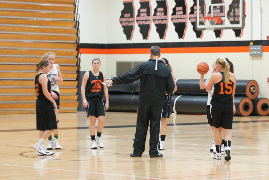 Coach Pedersen meets with his players during a practice.