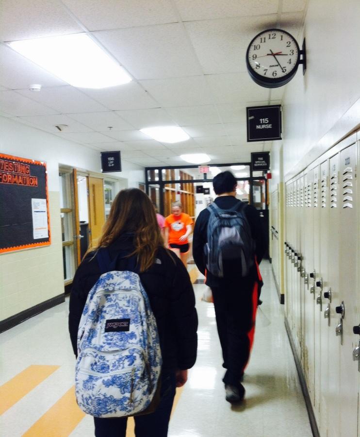 Freshman students Madeline Bartusch and Aaron Chen are seen walking in the hallways, similarly to how students would walk before hearing the music start playing in the halls.