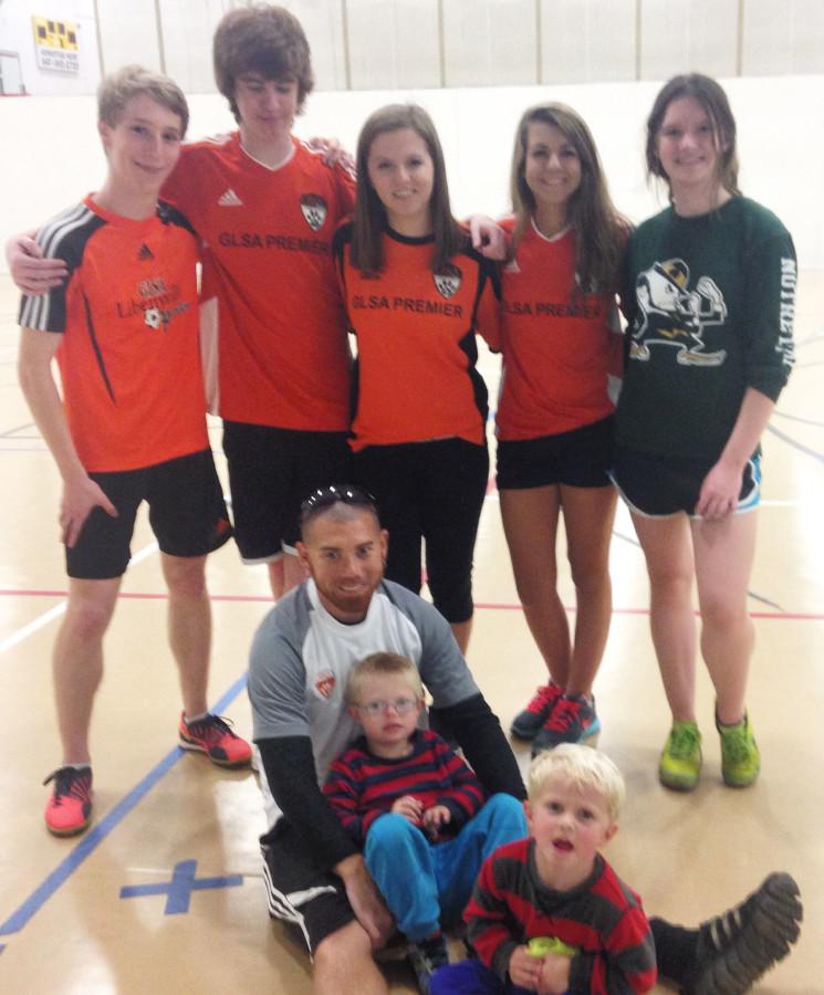 Bridget and other volunteers pose for a photo after playing soccer in the sports complex with kids who have disabilities for a program called TOPS.