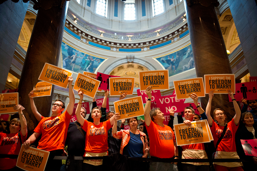 Advocates for both sides of allowing same-sex marriage protest in the entrance to the House floor at the Minnesoate state Capitol in 2013. The court decision will take place in the spring of 2015.