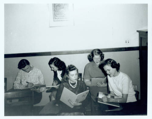 Students share and sign copies of the 1947 school yearbook, the Nautilus. From left to right are Don Berkley, Betty Carberry, unknown, Marilyn Covert and Joan Baker.