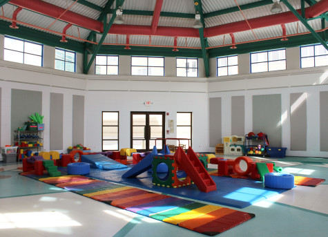 In the gym, the kids are able to utilize many different toys and have a large, open space to run around and play.