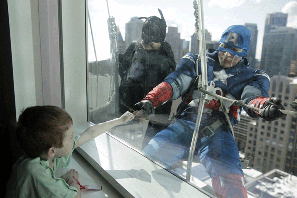 Window washers at Ann & Robert H. Lurie Childrens Hospital in Chicago dress up as superheroes to surprise children staying at the hospital. 