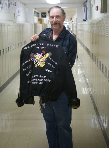 Taormina with his old Navy jacket, which displays the places the USS Seattle traveled while he was on it.