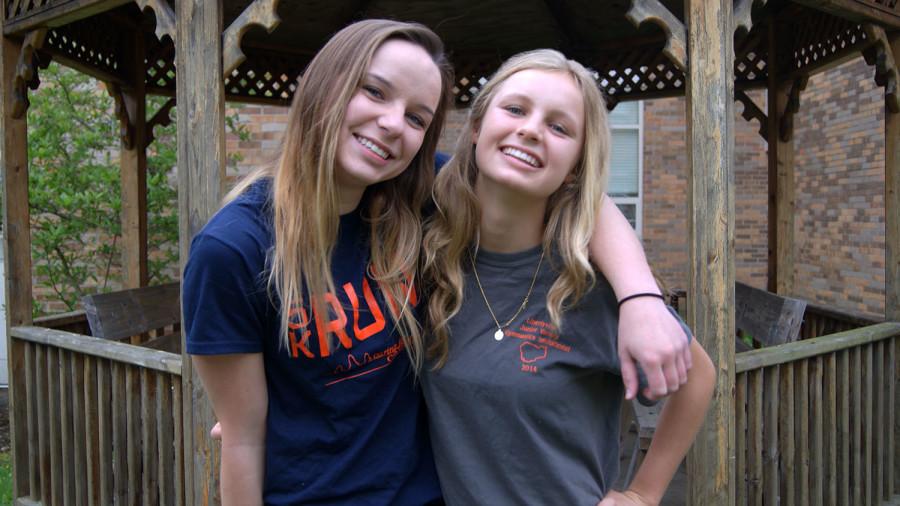 Sophomores Morgan Paul (left) and Taylor Underwood (right) proudly wear their Caring for Cambodia fundraiser shirts.