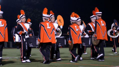 "The drum feature is my favorite part ofaperforming at halftime because it's the one time drumline can really showcase what we're capable of and what we've been working on in rehearsal," said junior Brandon Tang (pictured above, left).