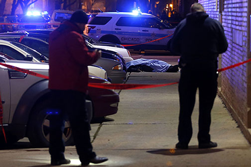 Chicago Police survey the area of a shooting. 