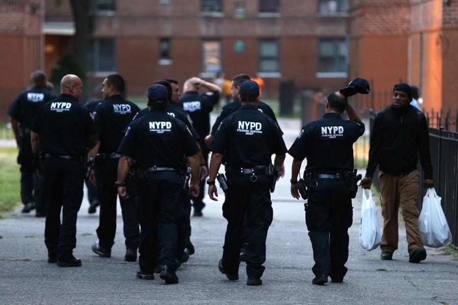 Members of a New York Police Department "strategic response group" remain on scene after a shooting in the Flatbush Gardens apartment complex on Aug. 29, 2015 in Brooklyn, N.Y. (Terrence Antonio James/Chicago Tribune/TNS)