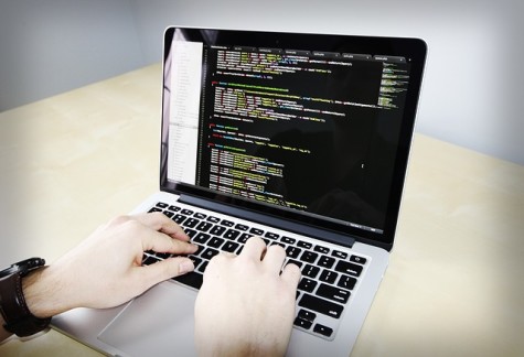 Coding is the inputting of commands into a computer to make games, apps, and other programs.