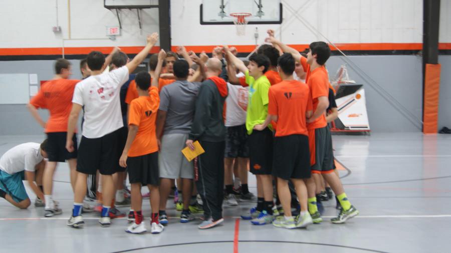 A group of players gather with the coaches and discuss what they can expect from this practice.