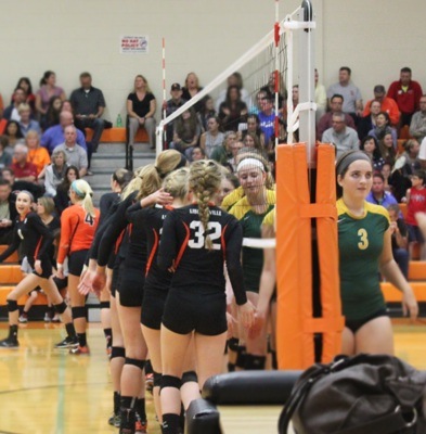 Volleyball teams from Libertyville and Stevenson line up at the net to wish each other good luck before the games.