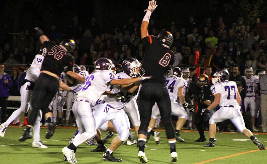 Defenders Sean O'Malley (56) and Ben Kimpler (8) apply pressure to Downers Grove North's offense. They helped the defense keep DGN scoreless in the second half.