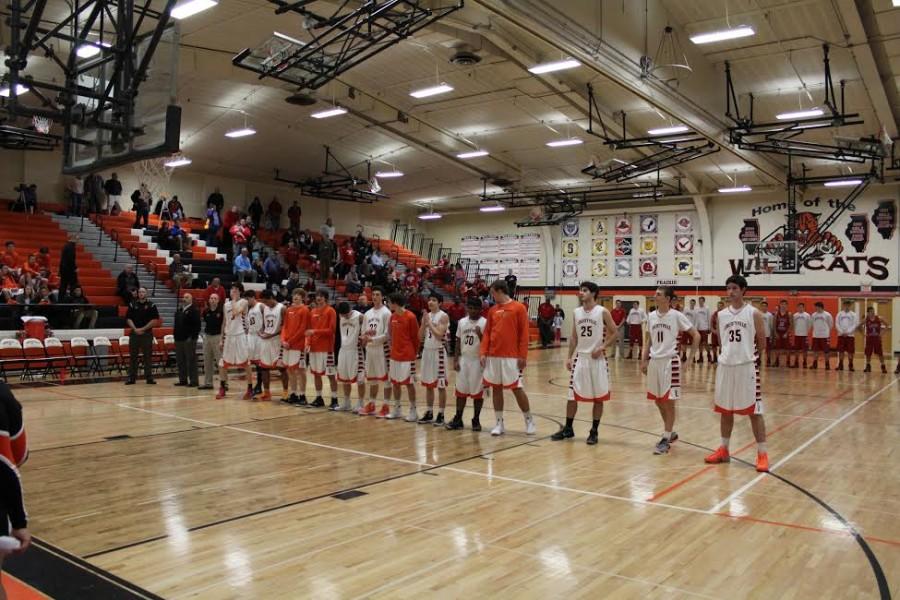 ​The boys varsity team lines up for the national anthem for the first home game of the season.