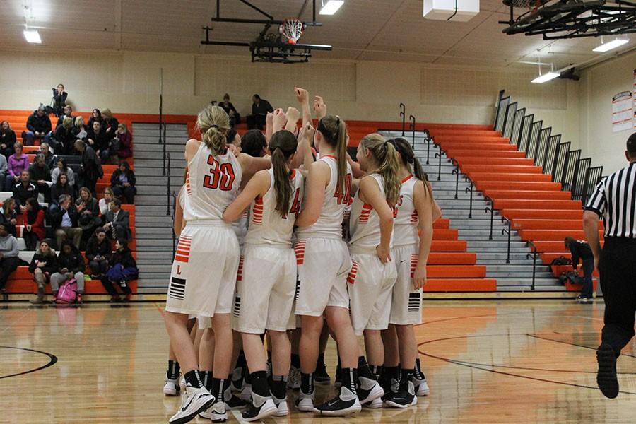 The team huddles to get hyped up before tip-off against Grant.