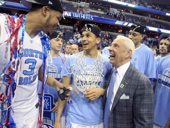 North Carolinas Kennedy Meeks, Marcus Paige, and head coach Roy Williams share a laugh after UNCs 61-57 victory against Virginia.