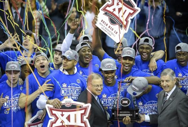 The Kansas Jayhawks celebrate with the championship trophy after beating the West Virginia.