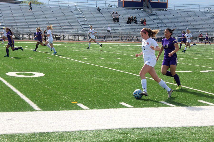 Sophomore+Makenna+Yoor+sprints+past+a+Waukegan+defender+in+Tuesdays+playoff+opener.