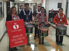 Mrs. Rukes, AP chemistry teacher, is congratulated by the school for winning the Golden Apple for Excellence in Teaching.