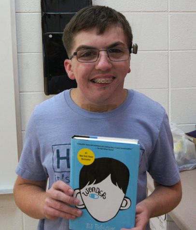 Dankelson holds "Wonder", a book whose main character has a similar story to his own.