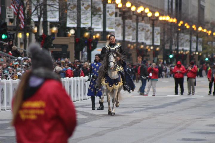   A Medieval Times knight rides down State Street in downtown Chicago to get the crowds ready for the battle.


