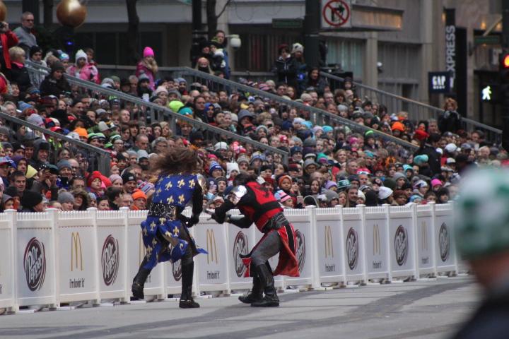  The battle begins between two men from opposing sides battle it out for victory to arouse the crowd for the parade which is soon to come. 


