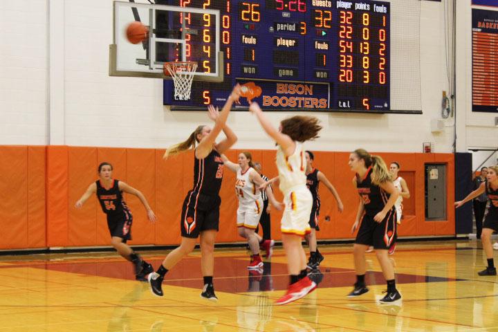 Maggie O'Sullivan blocks a shot, as Claire Keefe chases after the ball.