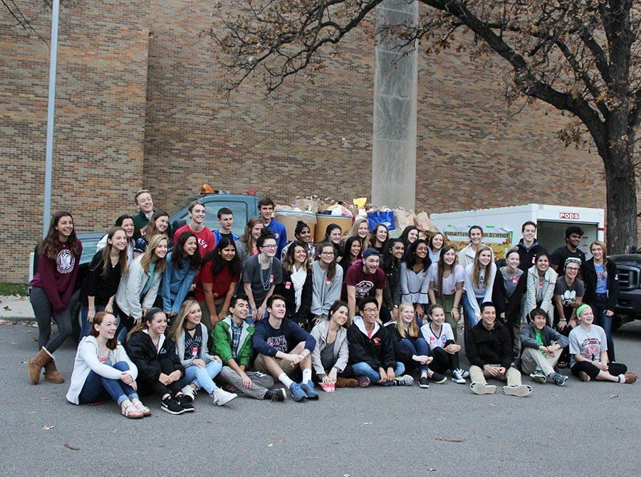 Student Council members pose for a group picture after they finished loading the cans to be sent to the Libertyville Food Pantry.