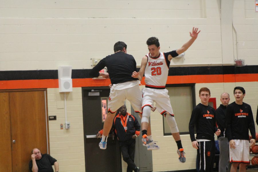 Senior Drew Fortini and junior Brandon Cook do their pregame ritual during the starting lineups. 