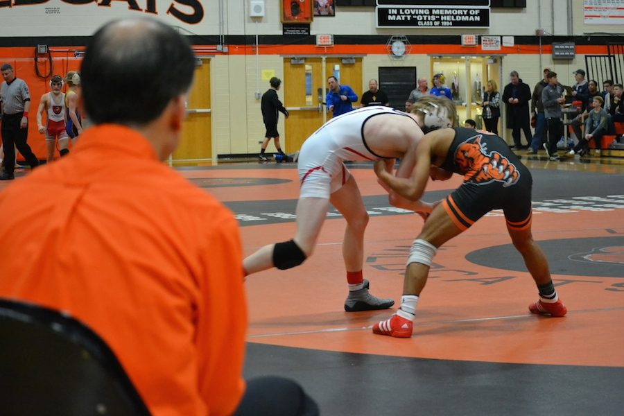 Senior Alex Mitchell (right)   came in first for his weight class and  advanced to sectionals.