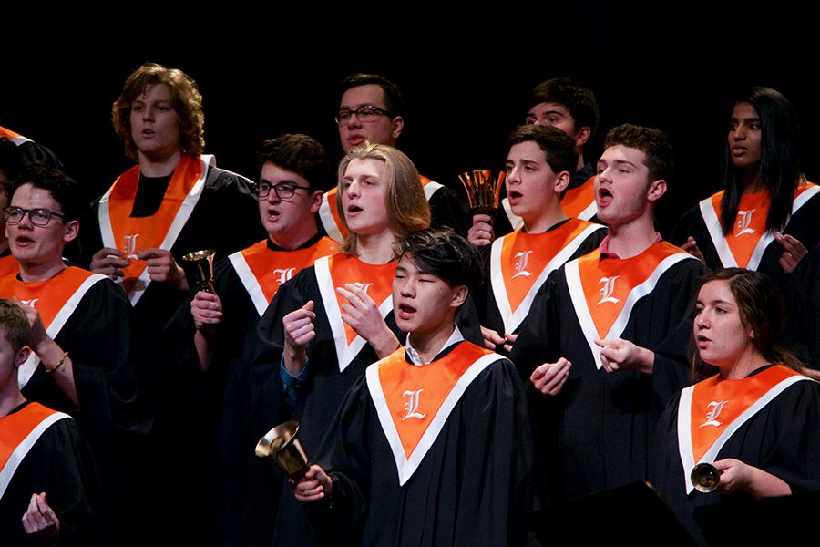 Students snap their fingers and revel the bells (both used as instruments), while singing “Cloudburst” by Eric Whitacre.